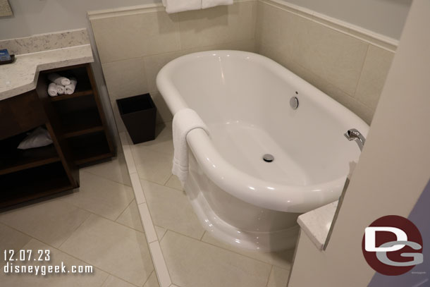 A tub in the bathroom area closest to the bedroom