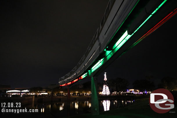 A Monorail passing overhead.. it has alternating red and green lights for the holidays