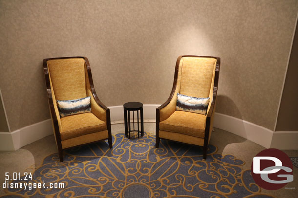 Some chairs near the elevator.