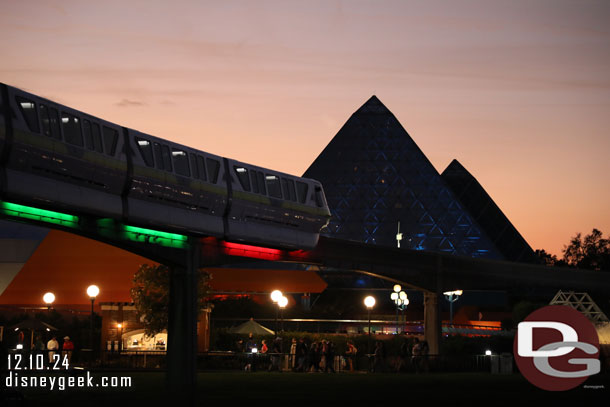 A Monorail passing by with red and green lights.