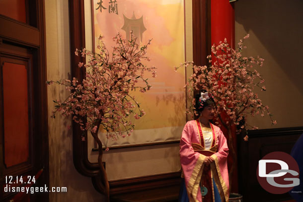 Mulan greeting guests nearby.