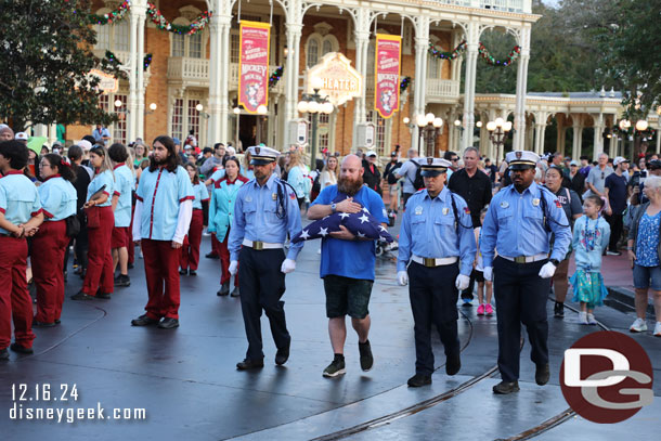 A guest veteran helps with the flag retreat