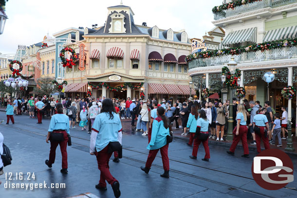 A number of cast members following the procession.